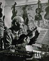 photo of William Russell tuning a violin