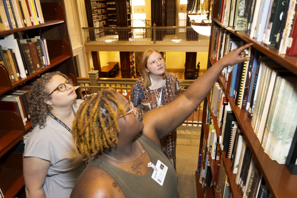 Interns browsing shelves in the WRC Reading Room