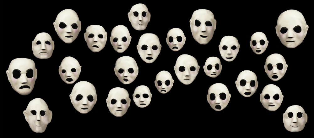 Assemblage of white masks against black background