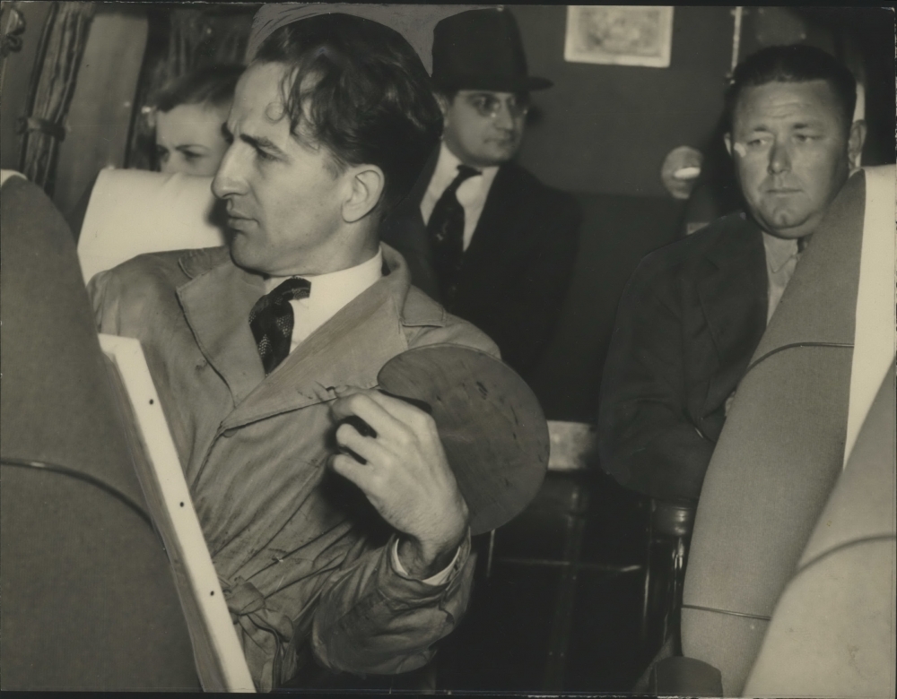 Black and white, 1930s photograph of H. Alvin Sharpe on a plane with a canvas in his lap and a painter's palette in his left hand. Image courtesy of The Times-Picayune | New Orleans Advocate