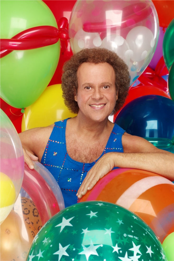 Ricard Simmons smiling and surrounded by balloons