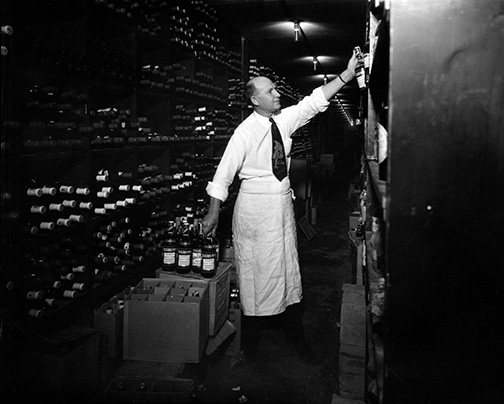 Interior view showing a sommelier stocking the wine celler at Antoine's.