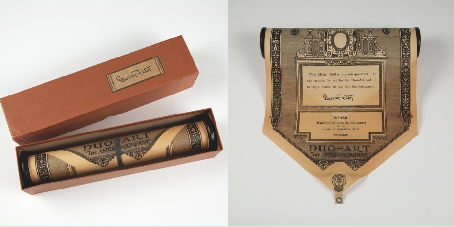 A player piano roll in and out of its box