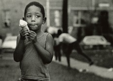 Boy eating melting ice cream cone